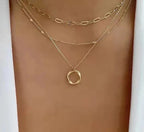 Layered gold-tone necklace with an open circle pendant